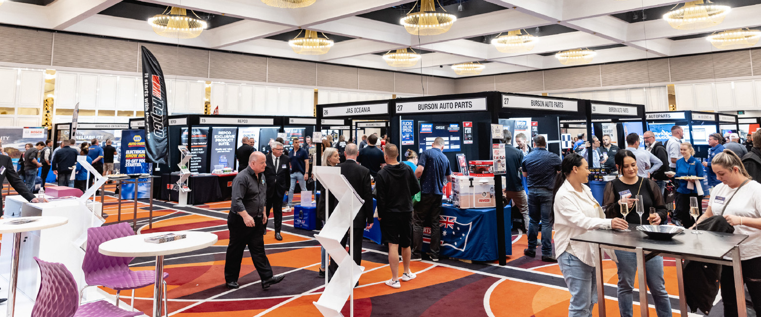 An energetic tradeshow bustling with attendees exploring numerous exhibition stands, creating a dynamic atmosphere of business and networking.