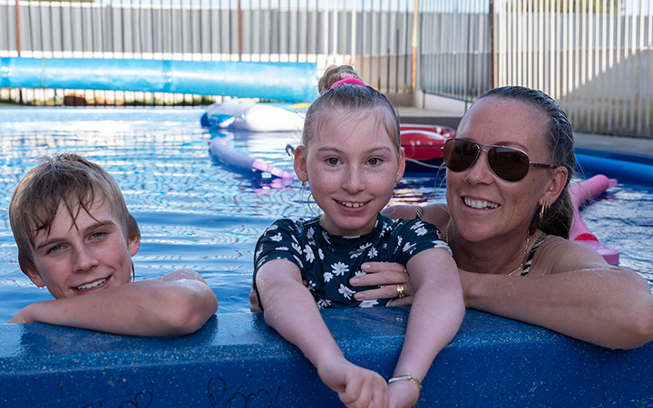 Pippa Funneman, her brother and mother smiling in their new pool