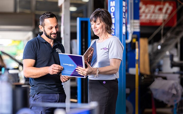 A Capricorn Member and Risk Account manager standing in a workshop