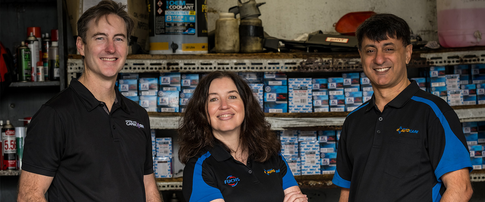 Brad Gannon, Moira and Patrick D'Cruz standing in a workshop smiling at the camera