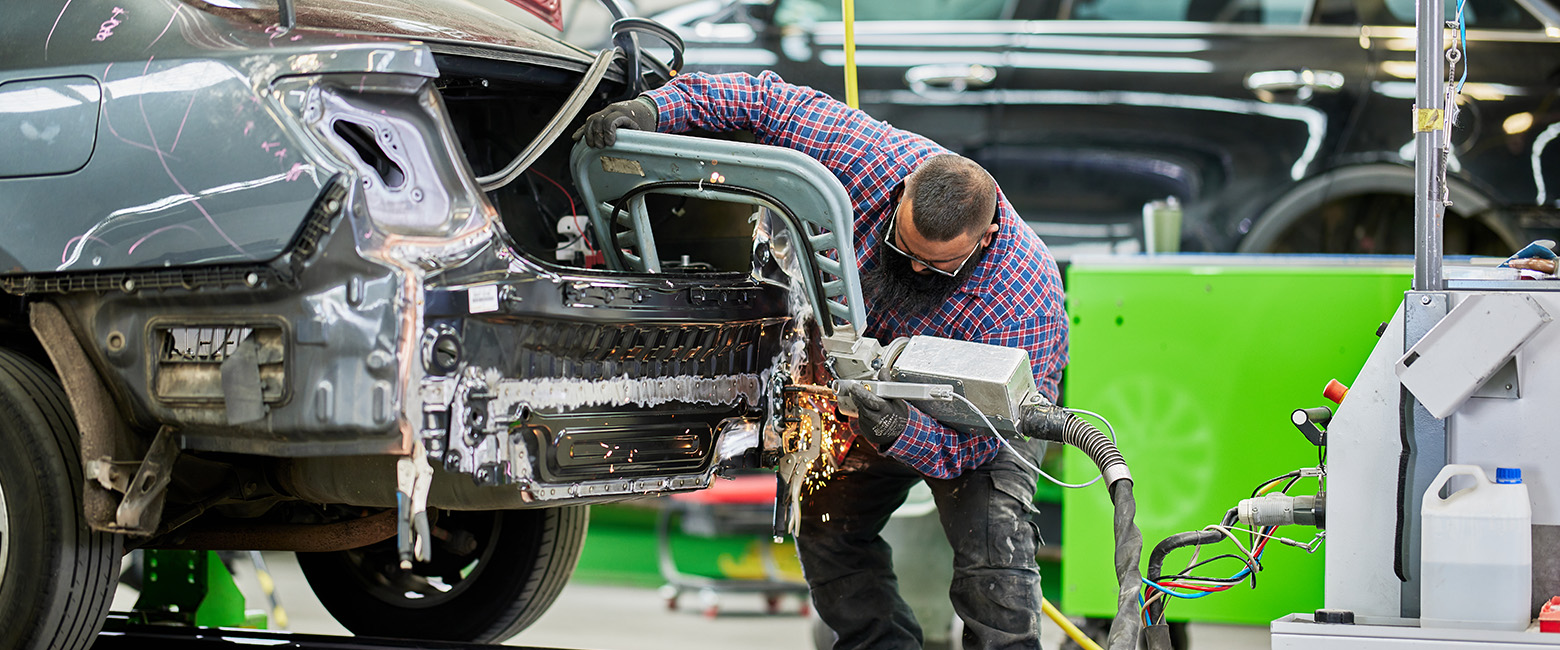 Mechanic working on a car in a garage.