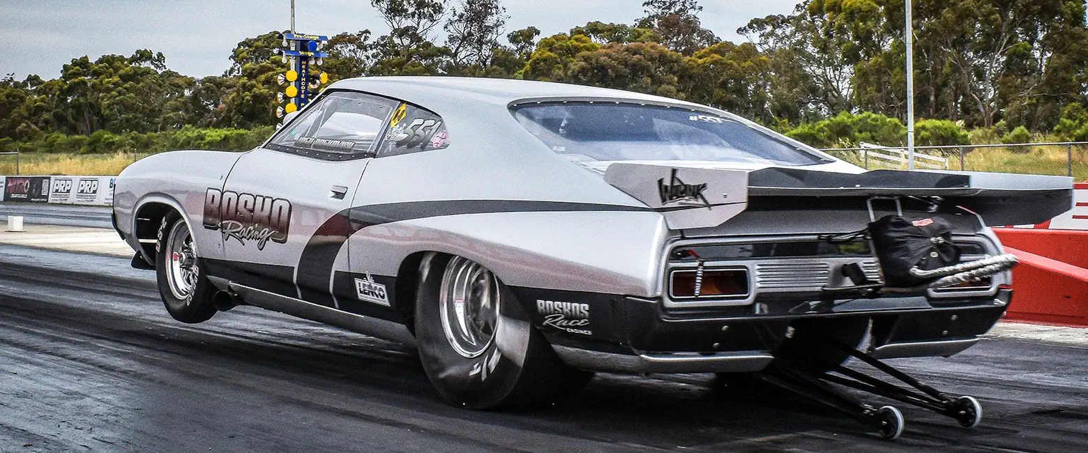 Ford Falcon XA Coupe drag racing car with a powerful engine on the track.