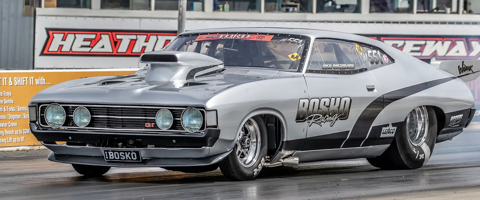 Ford Falcon XA Coupe drag racing car with a powerful engine on the track.