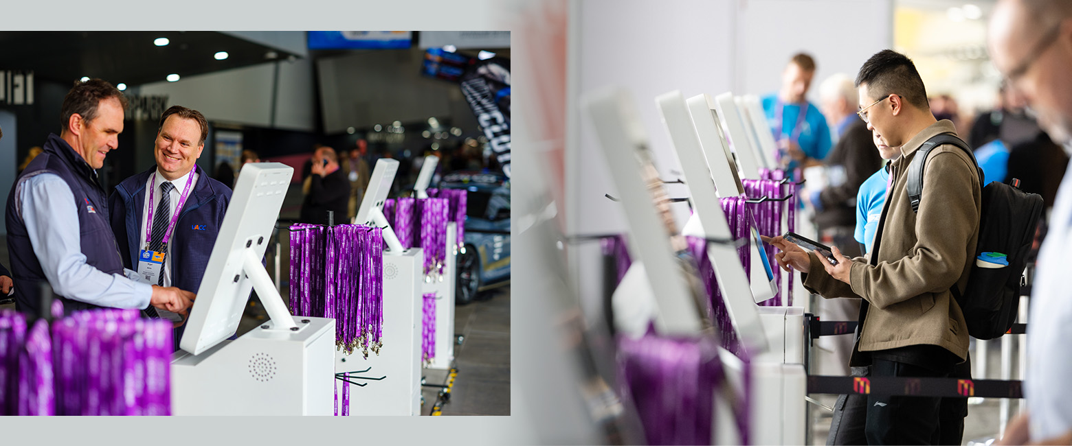 Pair of individuals next to purple ribbon machines.